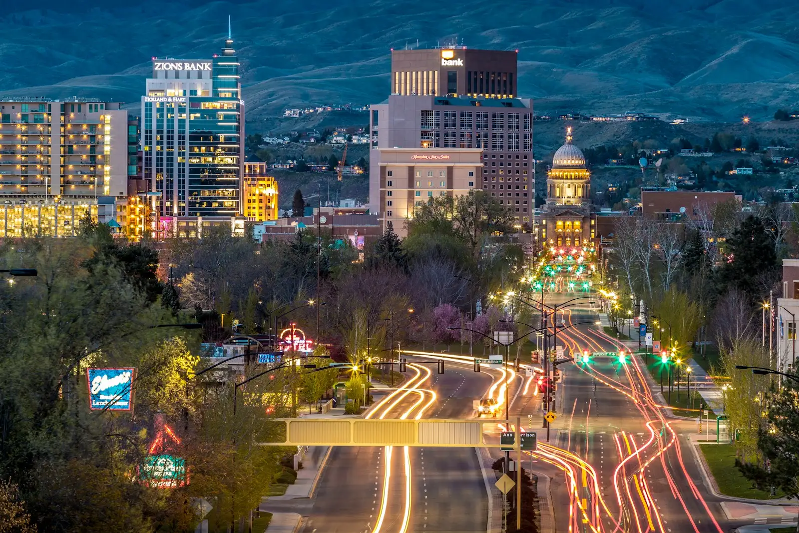 Illuminated concrete buildings and traffic lights at night in downtown Boise, Idaho.